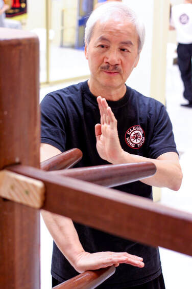 Sifu Elmond Leung Senior Wing Tsun Kung Fu Instructor demonstrating wooden dummy techniques in 2014